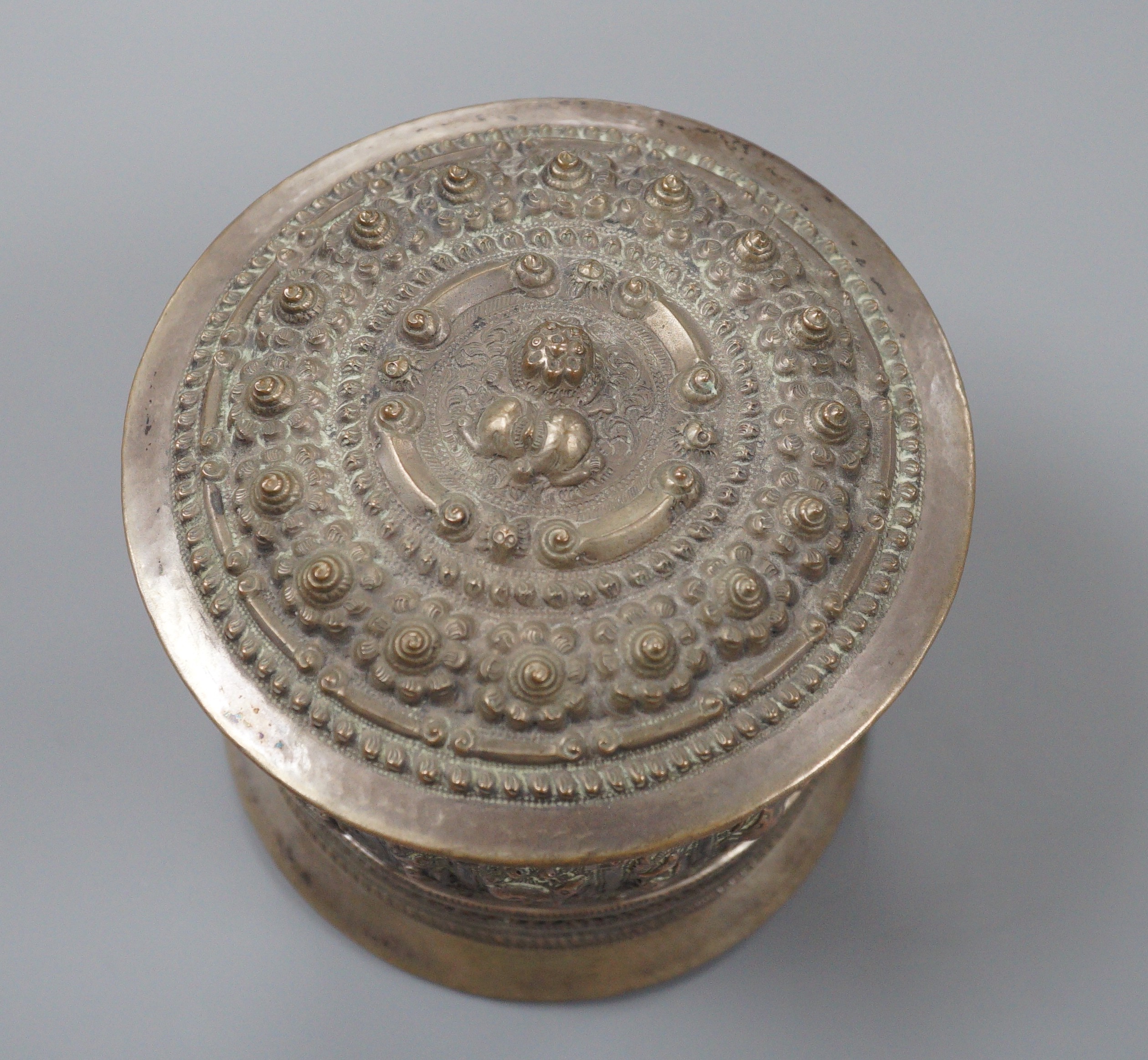 A 19th century Shan people white metal circular betel box and cover, Eastern Burma, height 10.5cm, 266 grams.